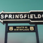 neon arrow-shaped sign with Springfield text inside and Route 66 shields